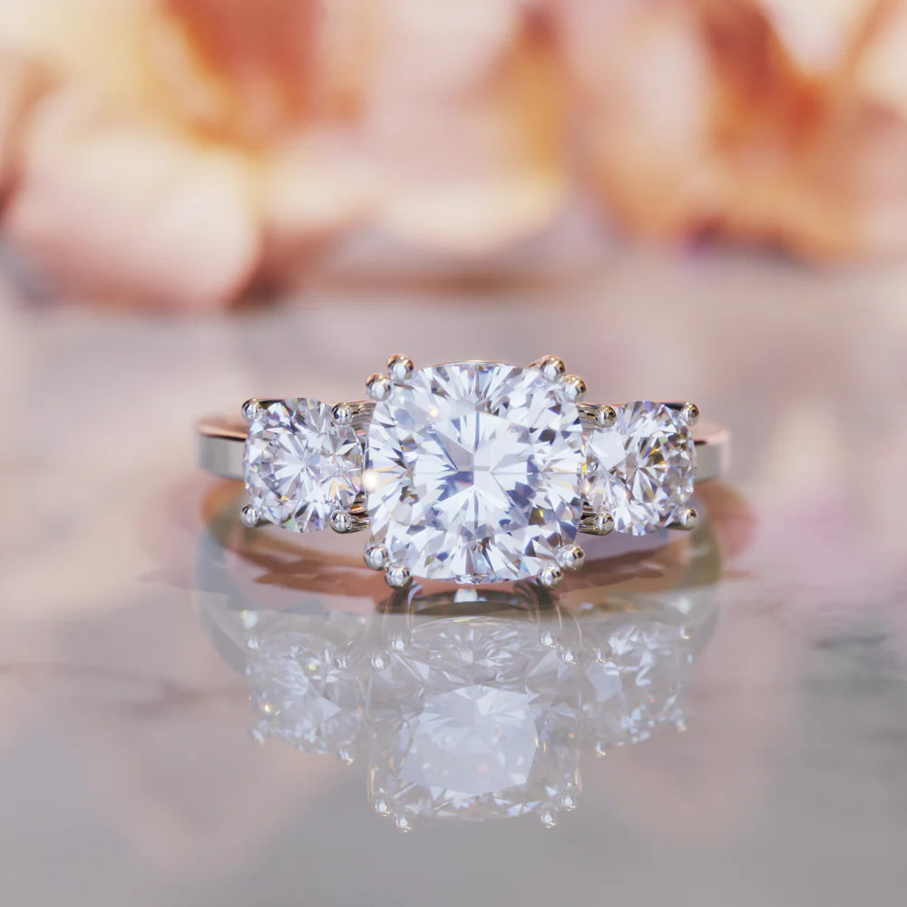 An image of the Lina, a 3.5CT triple stone moissanite ring sparkling beautifully.