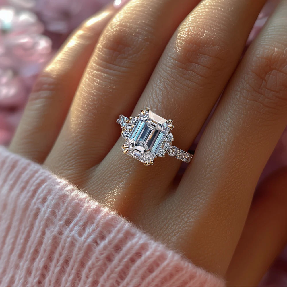 Photo of woman wearing the Natalia Light moissanite ring, a beautiful 2CT emerald cut moissanite ring