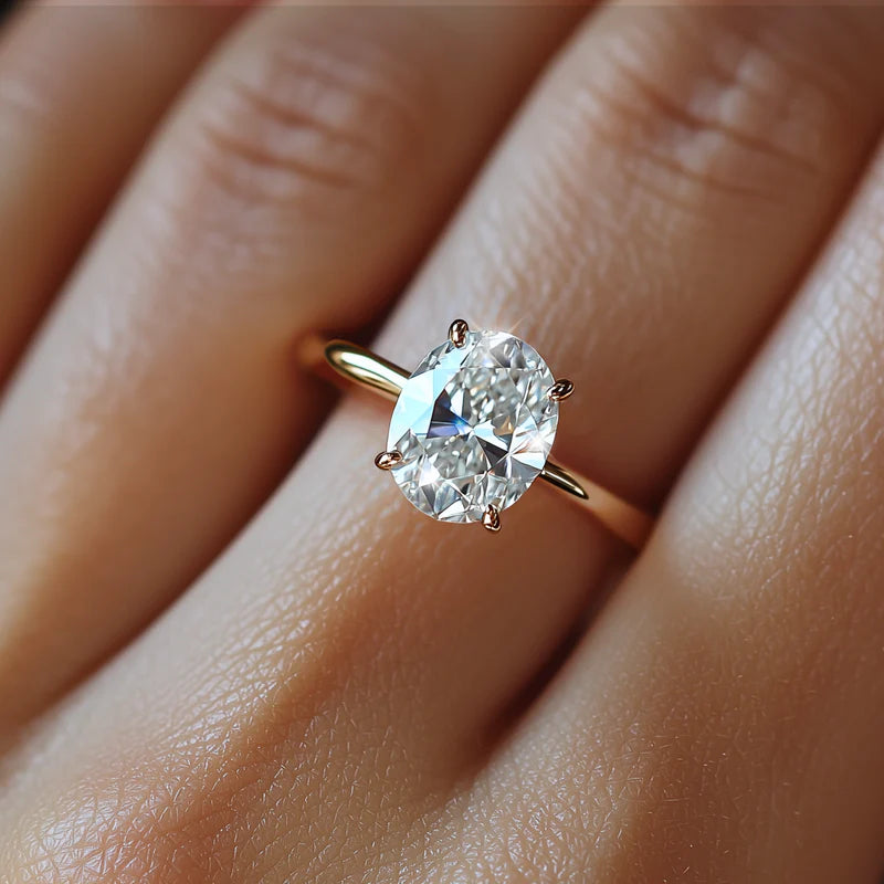 Model wearing a beautiful oval cut moissanite ring on her hand in a close up zoomed setting