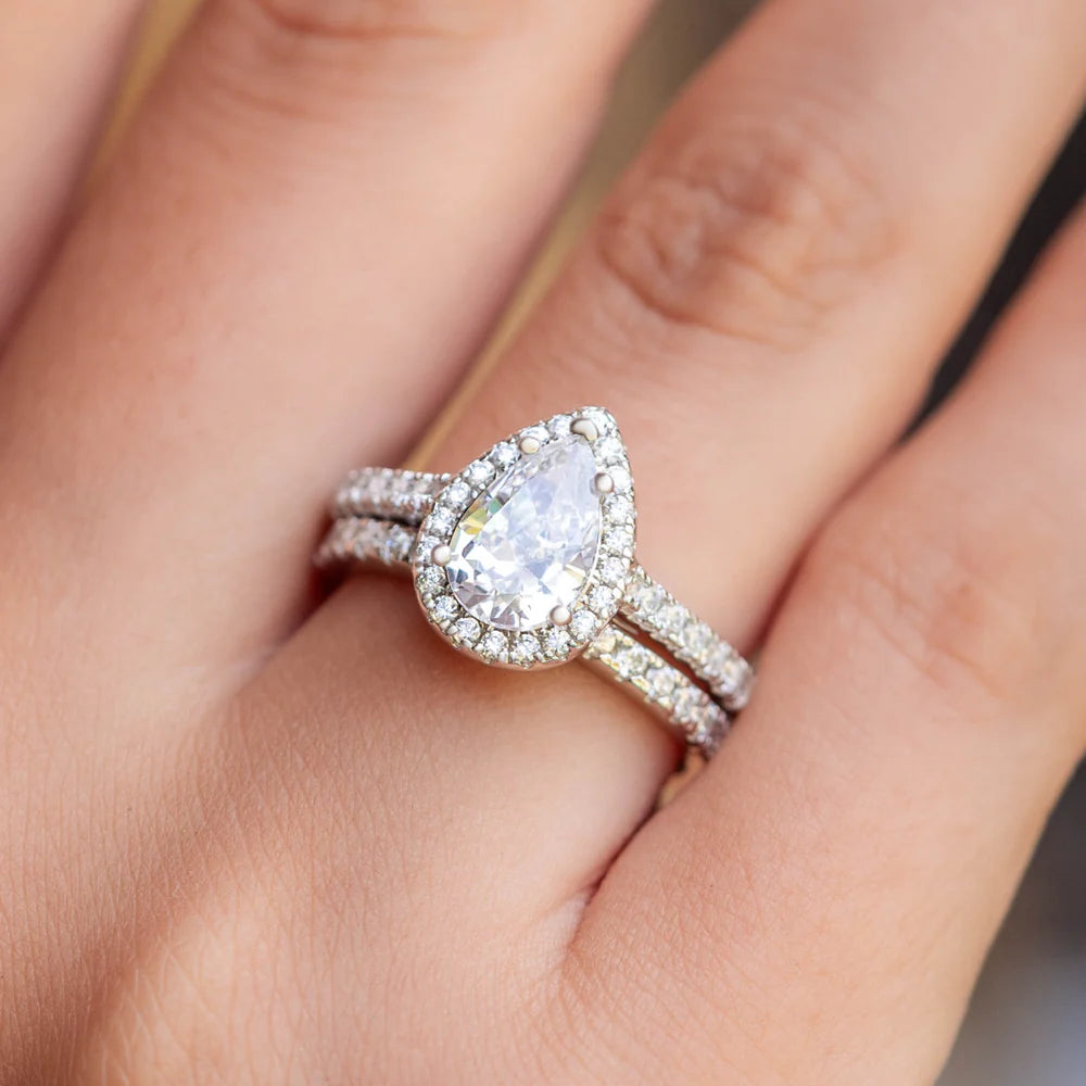 The Allure, a 2CT pear cut moissanite ring in a double pavé band