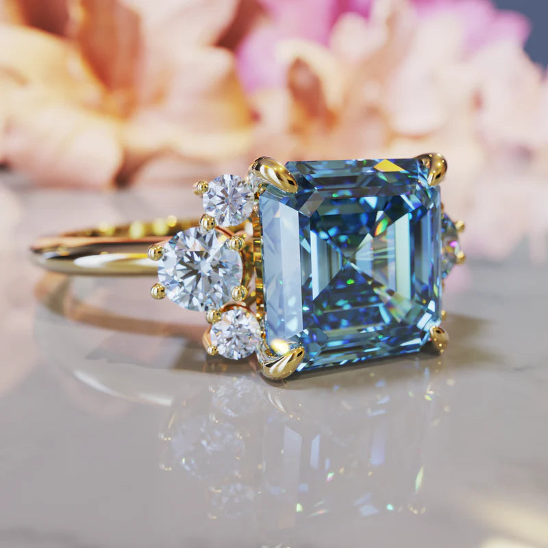 Side angle of the Ulissa blue moissanite ring, close up profile picture of this blue stunning asscher cut moissanite ring