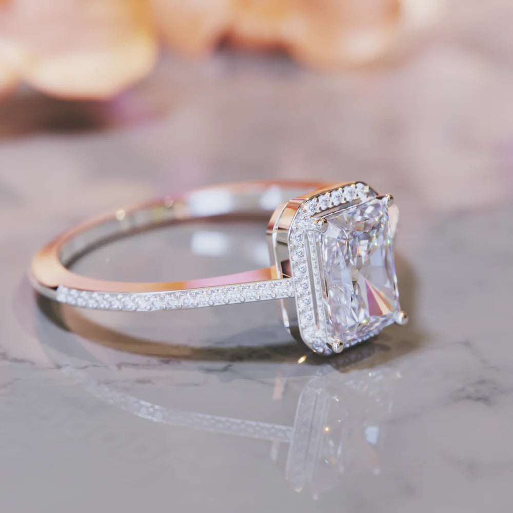 A 1CT radiant cut moissanite ring set in a beautiful halo of smaller moissanite stones