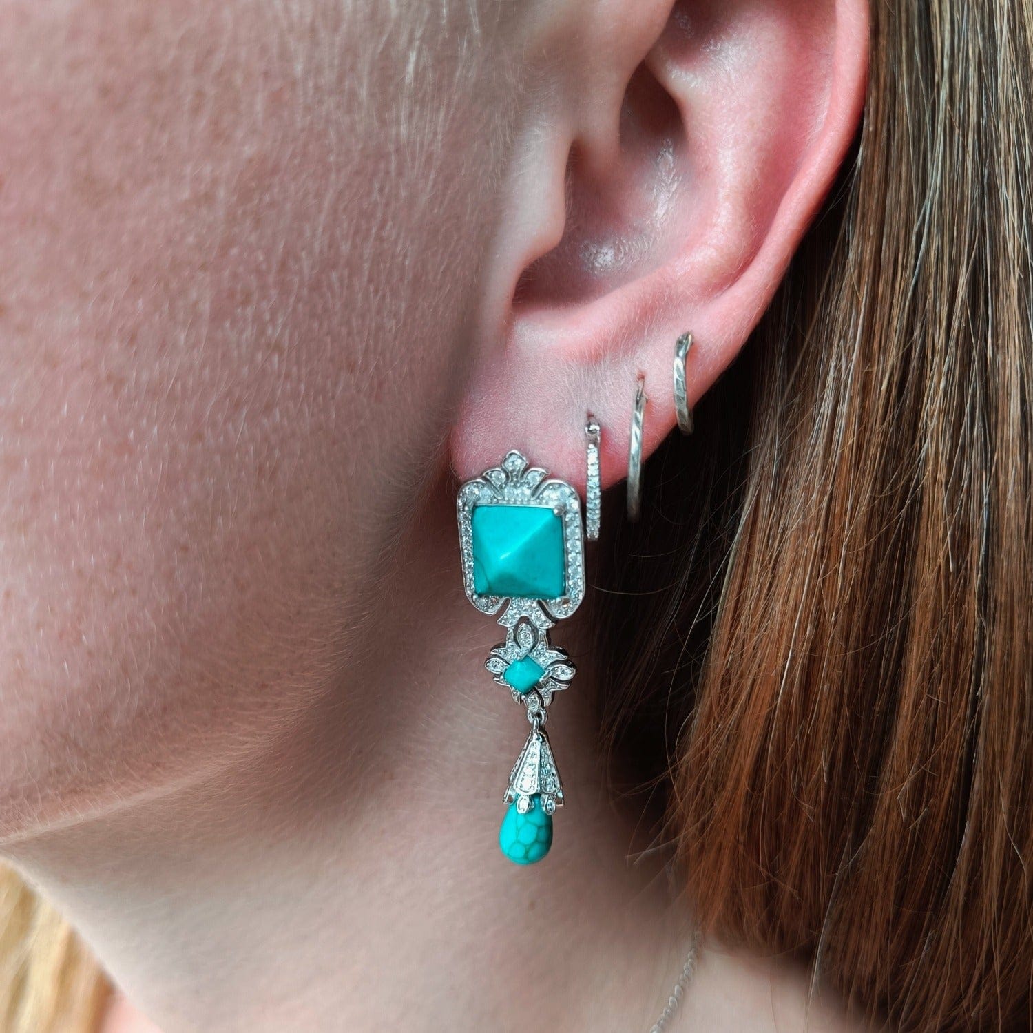 Turquoise Seabed Earrings featuring turquoise stones in a sterling silver setting on a model natural look